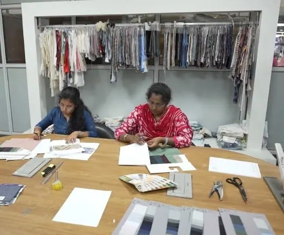 Design team reviewing fabrics, sketches and colour references