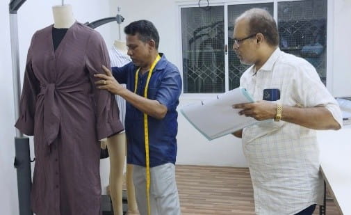 Quality team checking garment fit on a dress form